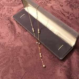 Gold necklace with small pearls.